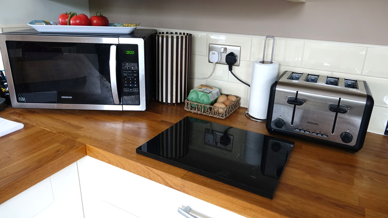 Microwave and toaster plugged into electrical outlet