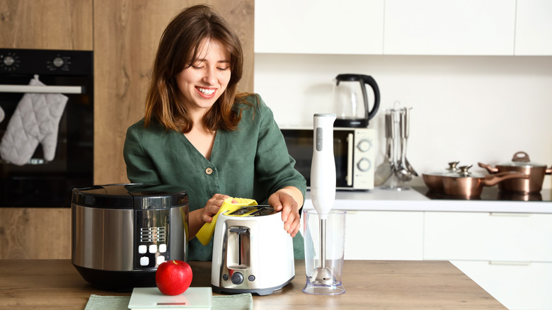 Woman cleaning a toaster