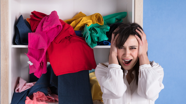 woman frustrated at messy closet