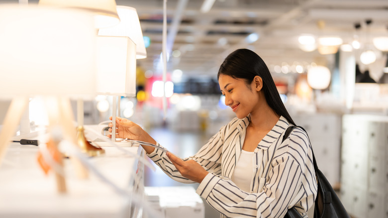 woman looking at lamps in the store