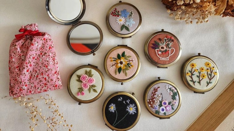 A collection of embroidered pocket mirrors