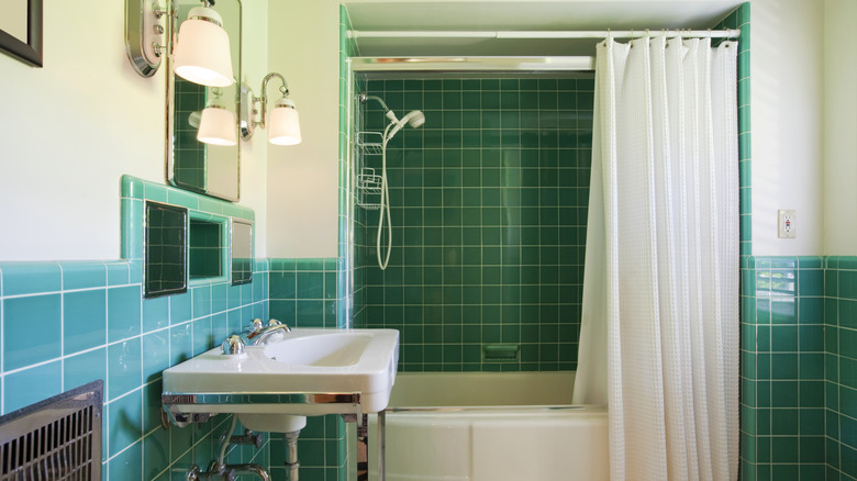 vintage 50s bathroom with blue-green tile and vintage fixtures