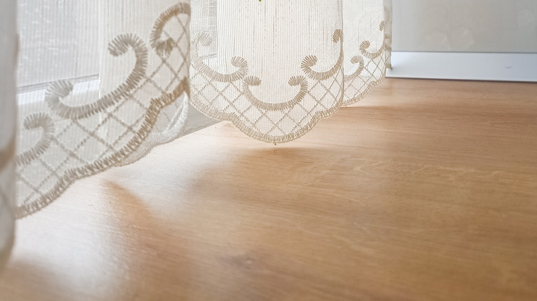 white sheer curtain with embroidery in home