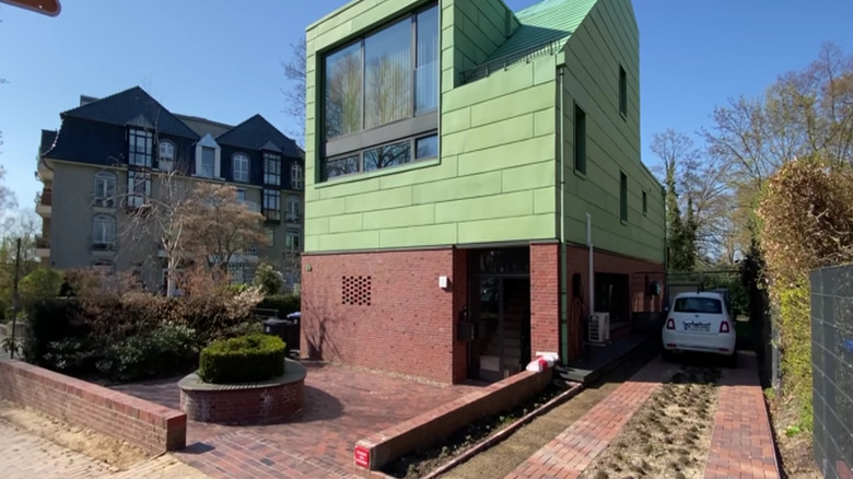 Brick ribbon driveway on the side of a house