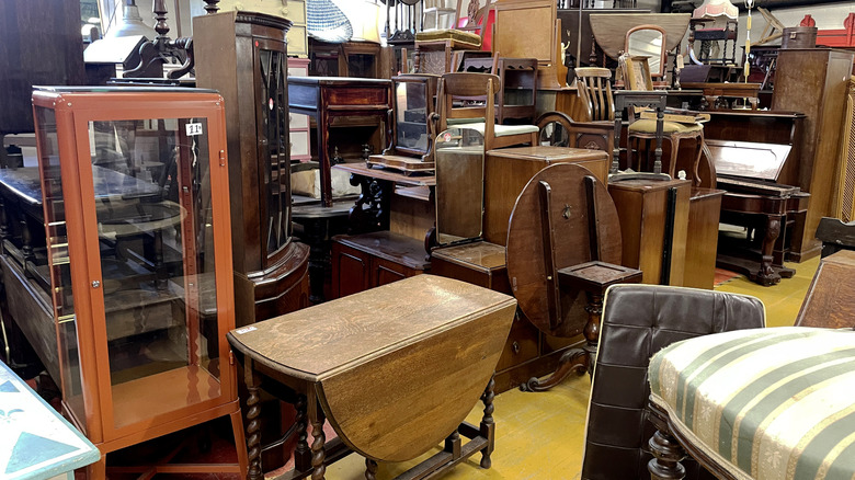Collection of used furniture on display in a thrift store.