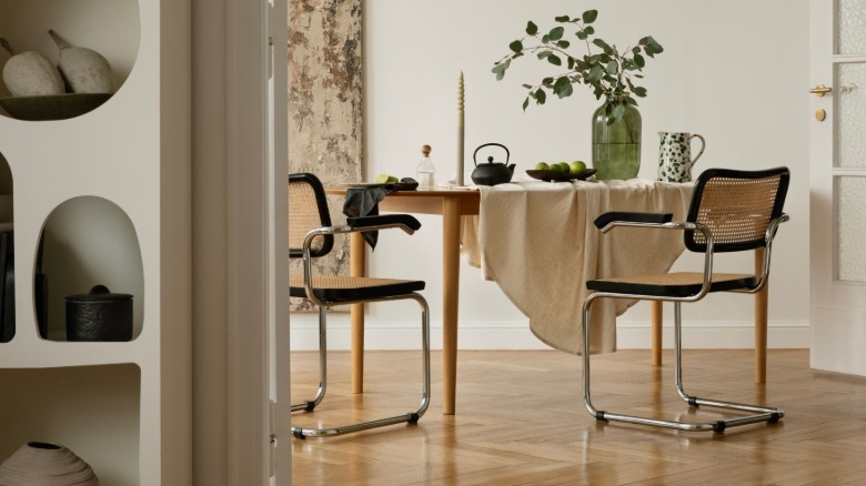 caned chairs at small dining table in modern interior