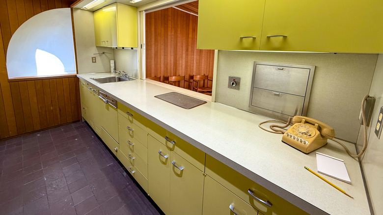 Pale blue metal kitchen cabinets with retro silver handles.