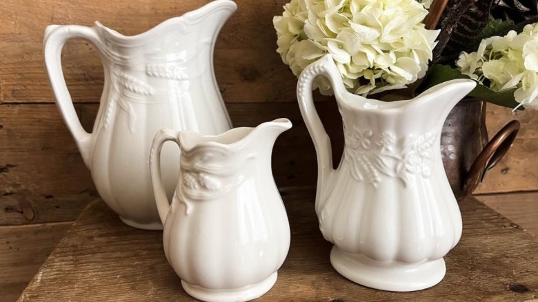 Set of three white vintage wheat pitchers