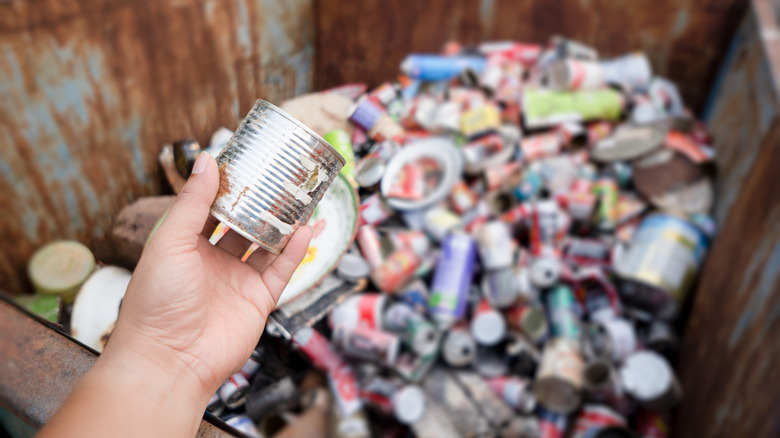 Pile of recycled aluminum in large rusty bin
