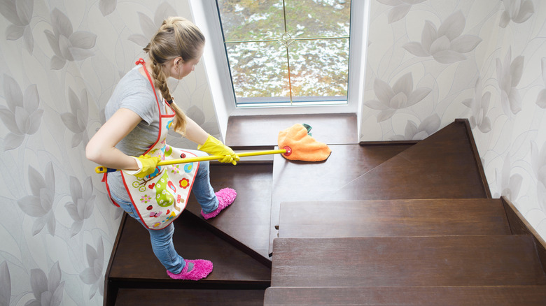 Woman cleaning staircase