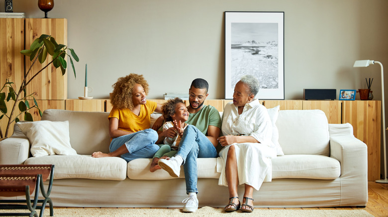 A family sitting on a sofa in a living room