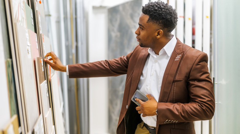 Man looking at tile options at a store