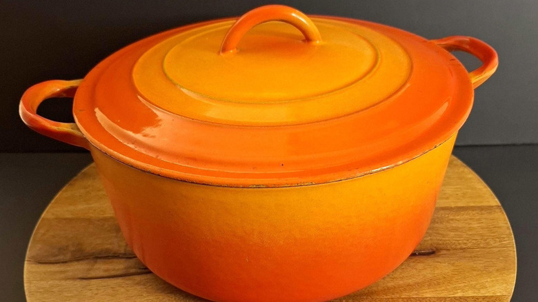 A vintage Le Creuset Dutch oven in the red-orange color