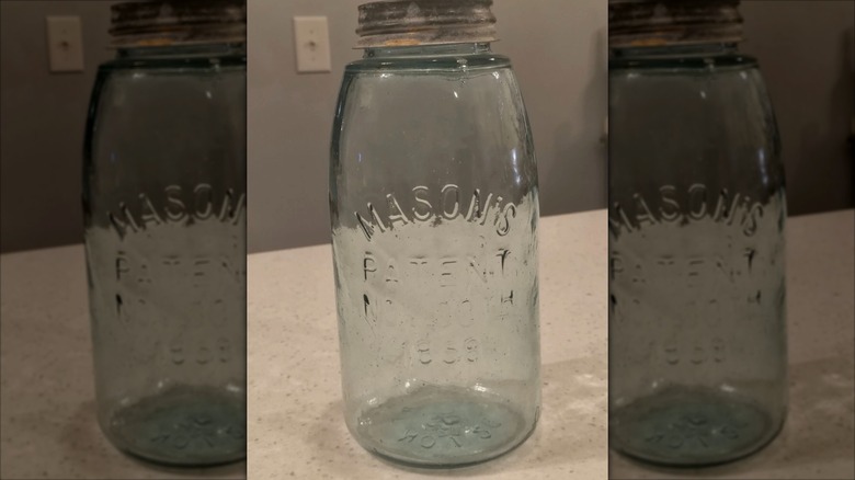 An original Mason jar sitting on a countertop