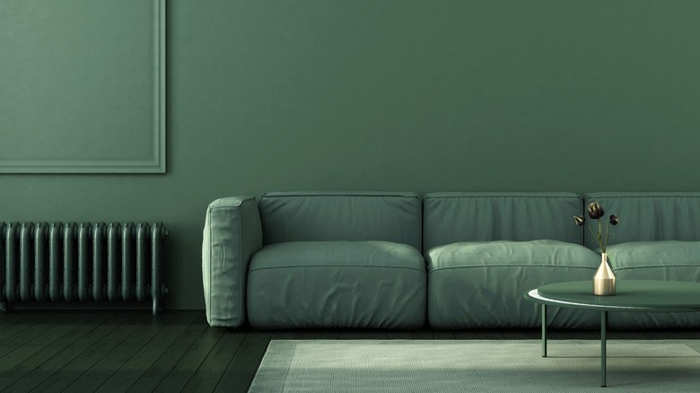 An all green color drenched room with a green couch