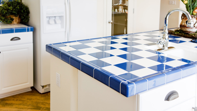 Kitchen with white and blue checkered tile countertops