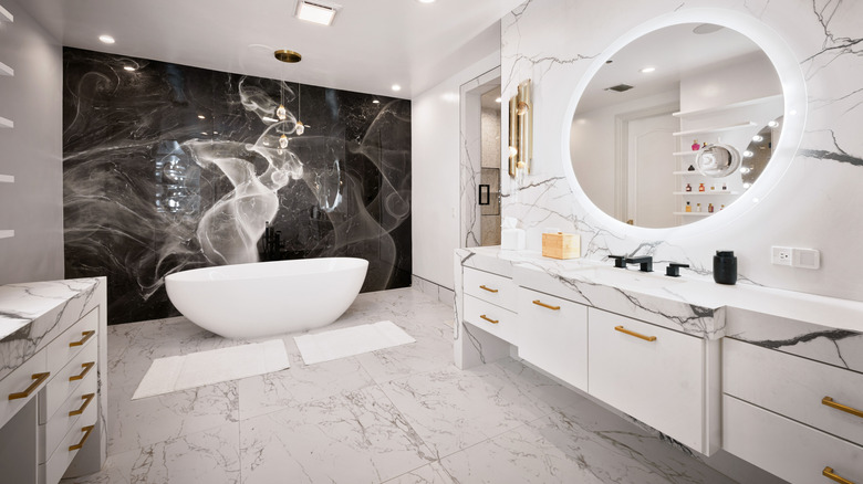 white bathroom with black feature wall and freestanding soaking tub