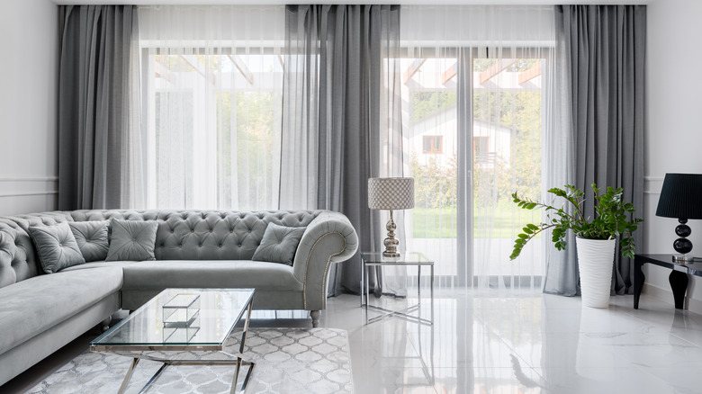 A glamorous living room decorated in shades of gray and silver