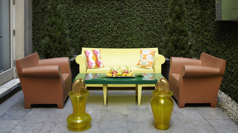 Outdoor patio space with different color furniture and cushions