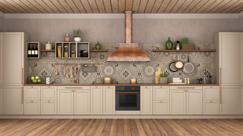 A kitchen with warm wood elements and copper items hanging from a shelf