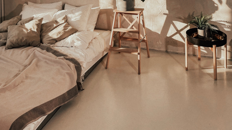 Sunny bedroom with stylish plastered walls