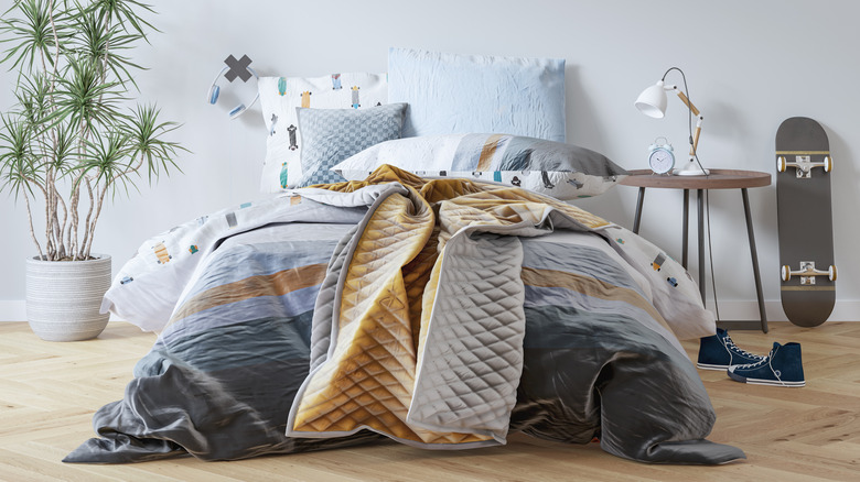 Bed with printed sheets and blue and orange