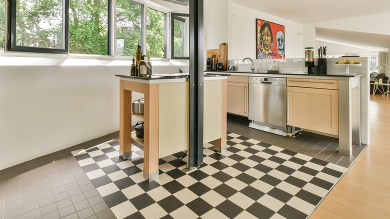 open and airy kitchen with black and white checkered tiled floor