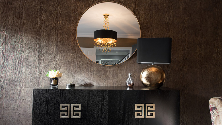 Black furniture with brown snakeskin wallpaper