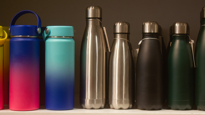 Reusable water bottles lined up on shelf