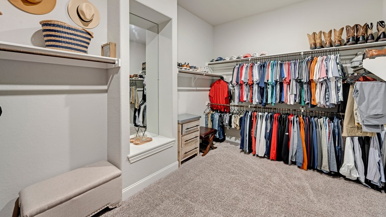 An organized carepeted walk-in closet