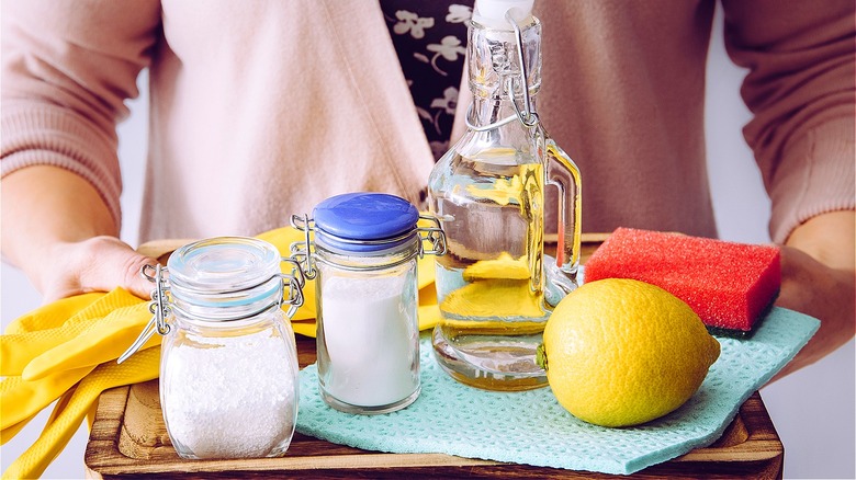 Woman cleaning sink with vinegar