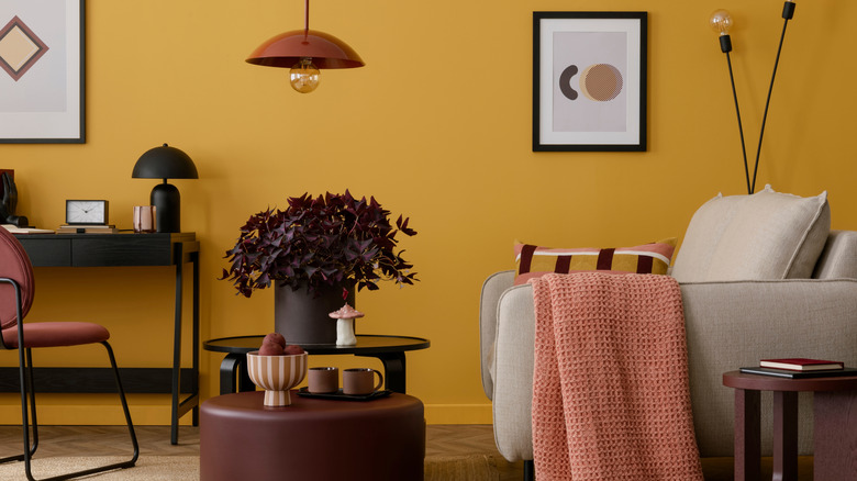 living room with a yellow, brown, and pink color scheme.