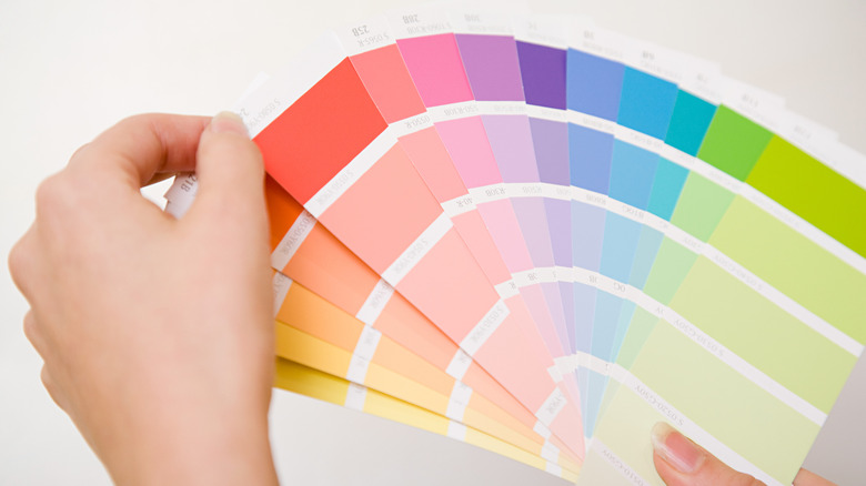 Someone looking through paint samples