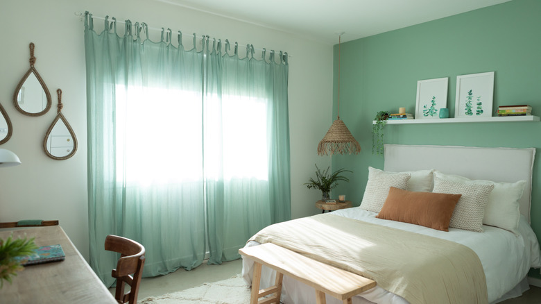 Light, airy bedroom with cream and green color tones