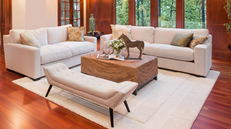 gray rug under leather couch