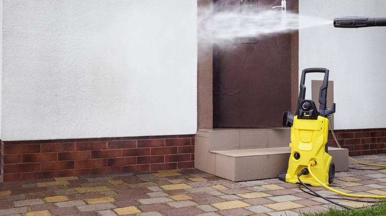 Pressure washer spraying around a front door