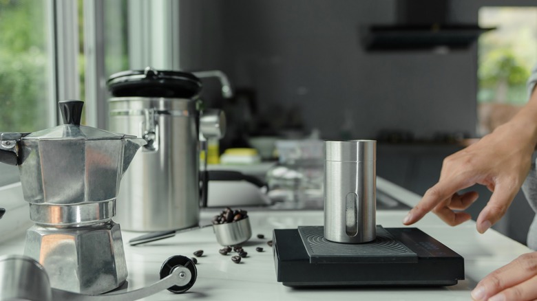 Person making coffee in kitchen