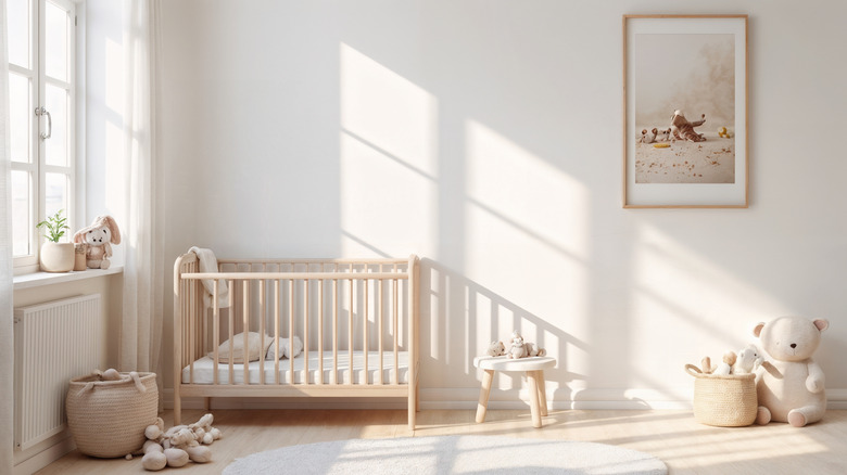 All-white child's room with crib, teddy bear, and stool.