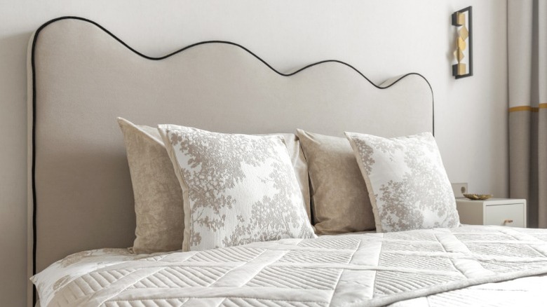Modern upholstered bed with simple wavy headboard shape