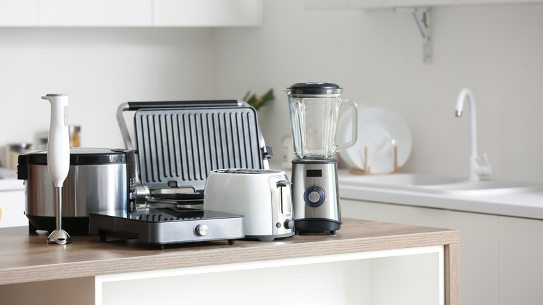Set of small modern kitchen appliances like blender and toaster