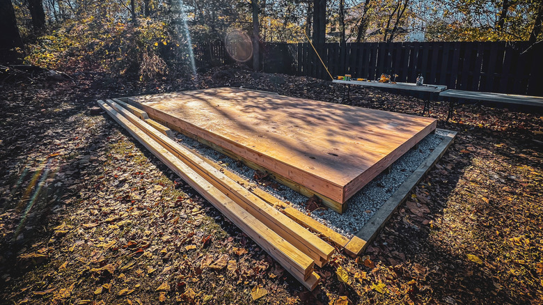 Wooden shed foundations laid on a gravel base with a gravel perimeter around the edge