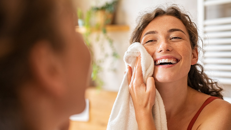 Smiling woman using towel