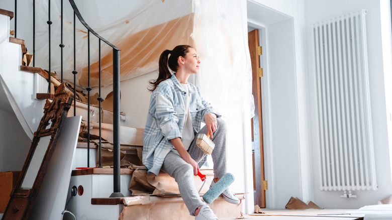 woman happily oversees home renovation