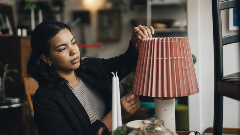 Woman adjusting a pretty vintage lampshade