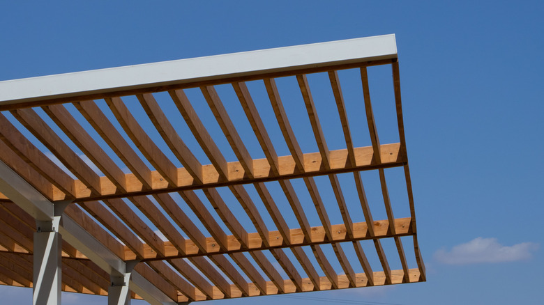 slatted roof made from wood and metal against blue sky