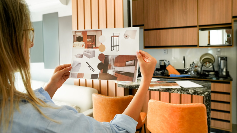 Person holding inspo design kitchen