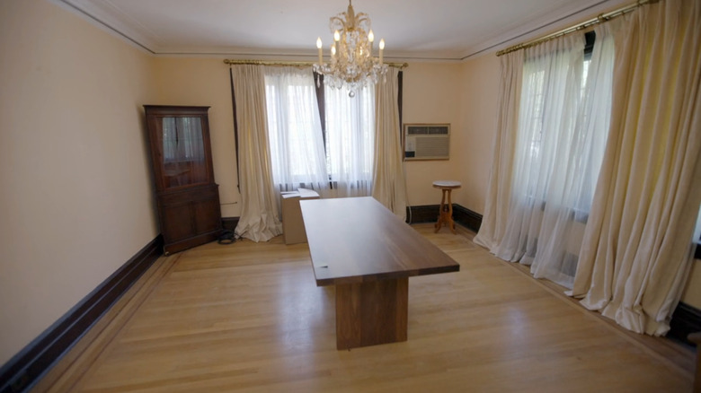 outdated formal living room with chandelier and table