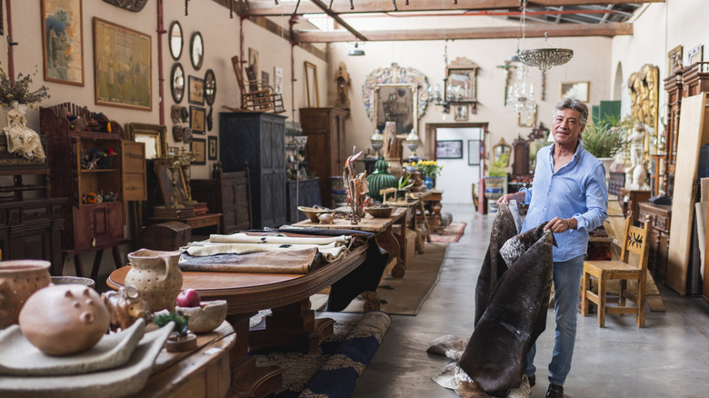 Person browsing home decor at a secondhand shop