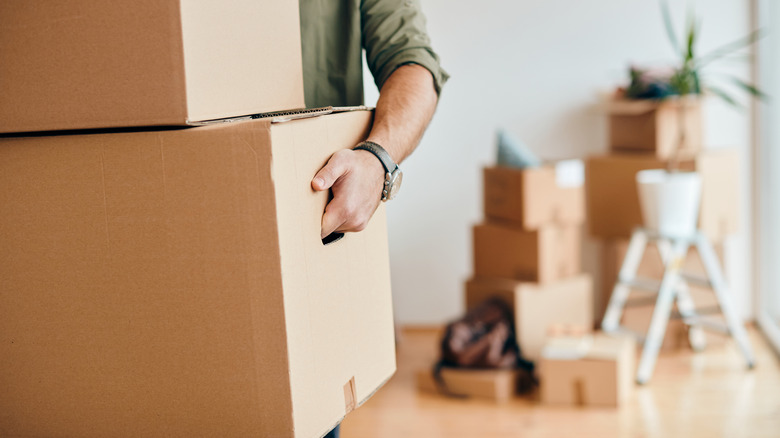 Person carrying moving boxes