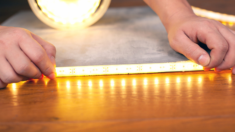 person installing LED light strips